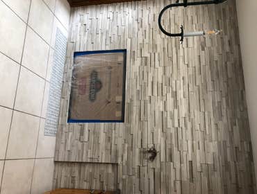 Photos by Schultz Contracting #1 Build fireplace box, Install fireplace, install stone wall, & Install Tile for Harth