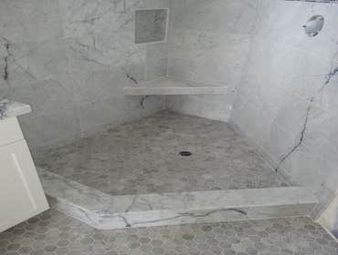 Kitchen and bathroom 12x24 marble on the shower walls and marble mosaic on the shower floor and bathroom floor. Subway tile backsplash in kitchen.