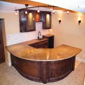 Basement Finishing Project Basement Finish in Overland Park featuring a radius wet bar.