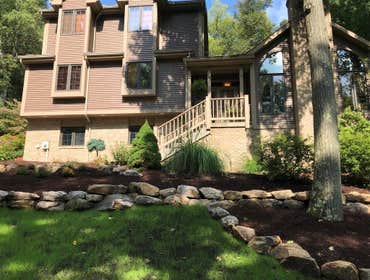 Wall Job in Export, PA Natural boulder wall with river rock bed and re-mulched surrounding beds.
