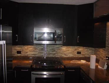 optima views condominiums Remodeling of entire Kitchen And Bathroom new cabinetry, flooring, and stone wall .