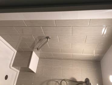 Photos by Battles Home Improvement Co Inc #1 Custom walk in shower complete with bench seat, recessed shampoo shelf, foot rest, safety bars and a hand