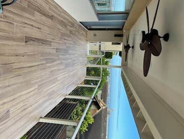 AFTER - 2 story deck in Aiea with cable railings, fans, recessed lighting and custom roof.