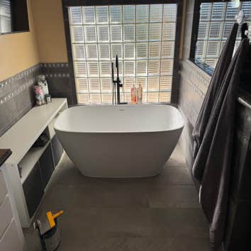 Photos by Gc Contractors #2 Removed old jacuzzi tub that was leaking. fixed leak and floor and added tile and a new standalone tub ordered by customer.