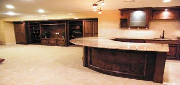 Basement Finishing Project Basement Finish in Overland Park featuring a radius wet bar.