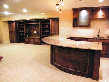 Basement Finishing Project Basement Finish in Overland Park featuring a radius wet bar.