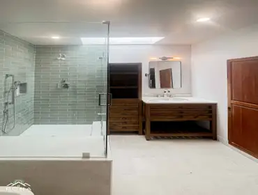 Culver City Bathroom Remodel We turned this Culver City bathroom into your own modern spa haven! Picture a warm wood vanity with sleek black handles an