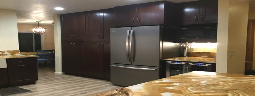 Kitchen Remove wall between kitchen and office to create open floor plan. Add new cabinets, flooring, appliances and lighting.