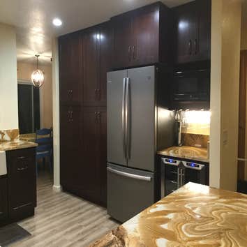 Kitchen Remove wall between kitchen and office to create open floor plan. Add new cabinets, flooring, appliances and lighting.