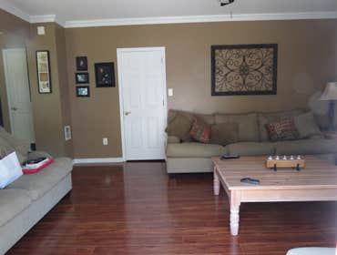 A family's living room and kitchen installed with laminate This project started out with us removing the old existing carpet in the living room and old
