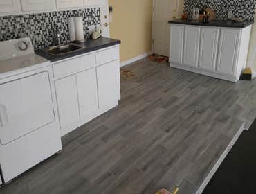 Garage Upgrage! New wood plank tile for laundry area and new vinyl flooring for the garage floor! Looks awesome!