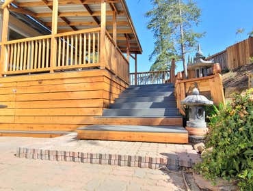 Large deck on hillside with staircase