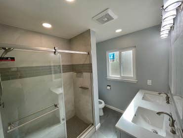 Grayish Bathroom Remodeling the old bathroom, removal of bathtub, new walk-in shower, tilling, faucet, double sink vanity, toilet, shower door .. .