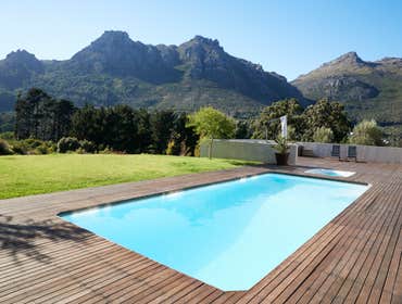 In ground pool with wood deck