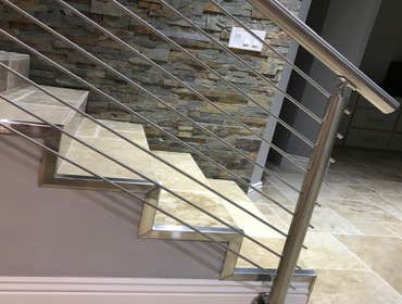 Photos by Brainz & Brawn Structures Inc #1 Stainless Steel bar handrail.. multi-tier stainless railing for interior staircase and basement access.