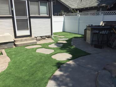 Back yard Stamp concrete, Turf and Vinyl fencing.