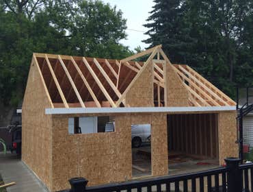 Photos by A-Windy City Garage Corporation #2 New garage construction with storage loft with built in stair case. Hardie Siding and upgraded overhead do