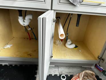 Photos by Des in the Cut Construction Company #1 We replaced a plastic, double-sink drain with pvc pipes, two P-traps and installed a vent so the water