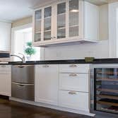 Modern Kitchen This kitchen remodel is about simple clean lines. We installed new hardwood flooring, custom cabinetry, granite counter-tops, new applia
