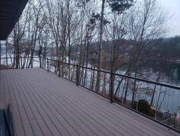 Azek composite deck w/vertical cable railing.