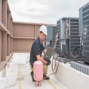 HVAC Engineer checking pressure in AC Unit