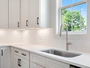 Bright chef-s kitchen at 1135 Delmas Ave, East Nashville by CJMC Build: Stainless Steel Sink and Pull Faucet