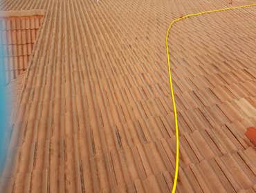 Photos from Popa Construction LLC Before & Afters of a soft wash roof cleaning and driveway and side walk cleaning.