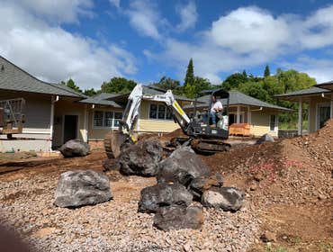 Installation of Boulder Retaining Wall as Part of Residential Renovation Landscape Design