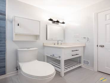 Alexandria Duplex Unit Bathroom Renovation This recent project captures a contemporary bathroom, featuring a striking contrast between the deep blue su
