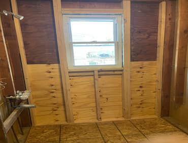 Before and after pictures of exterior wall repair and window replacement.