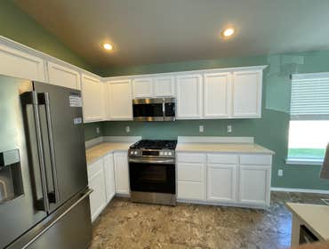 New Kitchen paint with quartz countertops Replaced old countertops with new quartz, repainted cabinets and accent walls.