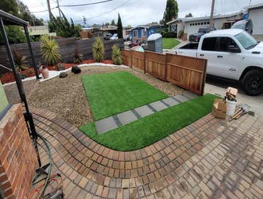 Photos by Landscaping La Economica LLC #1 Installed artificial turf, paver stone walkway, decorative mulch, and a new wooden fence. This project provid