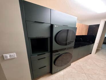 Interior View of Full Laundry Wall, Cabinets and Appliances Match