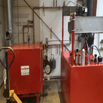 Photo(s) from Radiant Floor Heating Specialist Commercial boiler room with Lochinvar boilers and piping, Trucking companies Clean Burn waste oil burnin