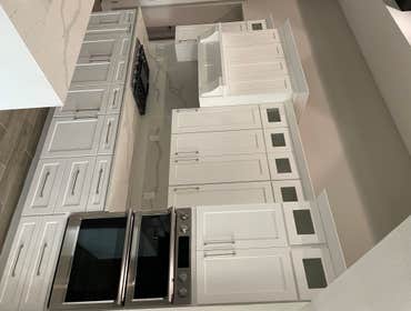 Photos by White Elephant Remodeling LLC #2 All real wood soft close cabinets dove tail and custom vent hood and Calcutta Quartz