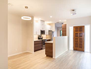 Vila Monterey Removed Kitchen drop ceiling and raised level with the rest of the home. Opened up kitchen by reframing ceiling and removing a wall. Open