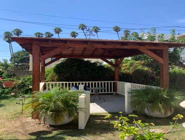 Photos by Idm Framing #3 costumer added 6 ft extension to the back porch, additionally she added a 11'x11' pergola with pyramid roof, deck was stained