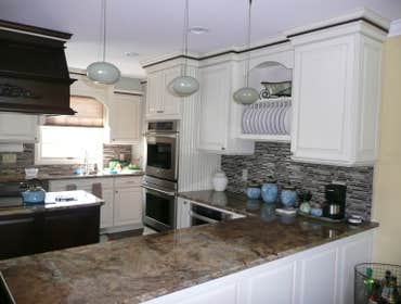 KITCHEN #3 This kitchen remodel included removal of a bearing wall which opened the dining room to the kitchen , separated by a bank of cabinets. This