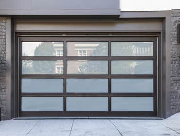 Glendale, CA - New Modern Garage Door One of our amazing projects, beautiful new garage door. Black metal frame with grey glass.