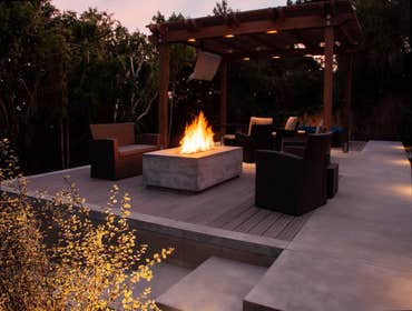 Photos by PacifiCoastal Design and Construction #2 Backyard remodel with fire feature, composite deck, custom concrete work, retaining walls, golf putt