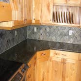 Project photos from Solid Surface Creations - DCI Stone Back Splash with Hood Stone Insert