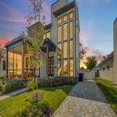 Ethereal Natural Light Modern, two-story residential house with large glass windows dominating the façade.
