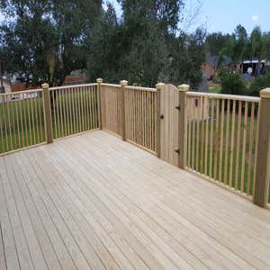 Dead On Decks 2nd story deck with custom railing and false door accent.