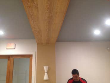 Downton miami wallcovering installation downton Miami store wood venier wall covering installation on ceilings