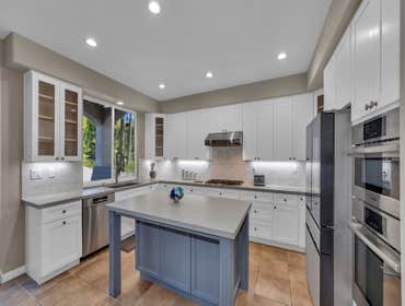 Kitchen Remodel We transformed our client’s kitchen with custom white shaker cabinets, a sleek quartz countertop, a beautifully installed backsplash, a