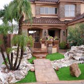 Photos by Desert Xeriscapes Inc #2 waterfalls, artificial grass, pygmy palms, flagstone bridge and walkway