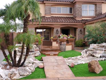 Photos by Desert Xeriscapes Inc #2 waterfalls, artificial grass, pygmy palms, flagstone bridge and walkway