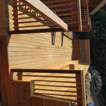 Broadway Terrace Back Deck Retaining wall with steps to a 28'x14' Redwood deck with 36' of bench.
