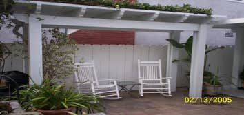 FreeStanding, Decks and Pavers Freestanding Bi-level Elitewood Lattice and Solid Patio Covers including Brown Beams, Sand Posts and Sand Trim. Deck in 