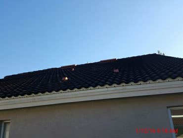 Photos from Popa Construction LLC Before & Afters of a soft wash roof cleaning and driveway and side walk cleaning.